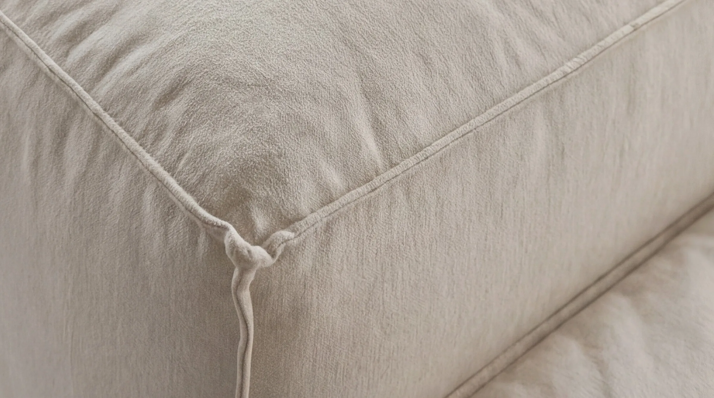 Corner seam in cream cotton, close-up