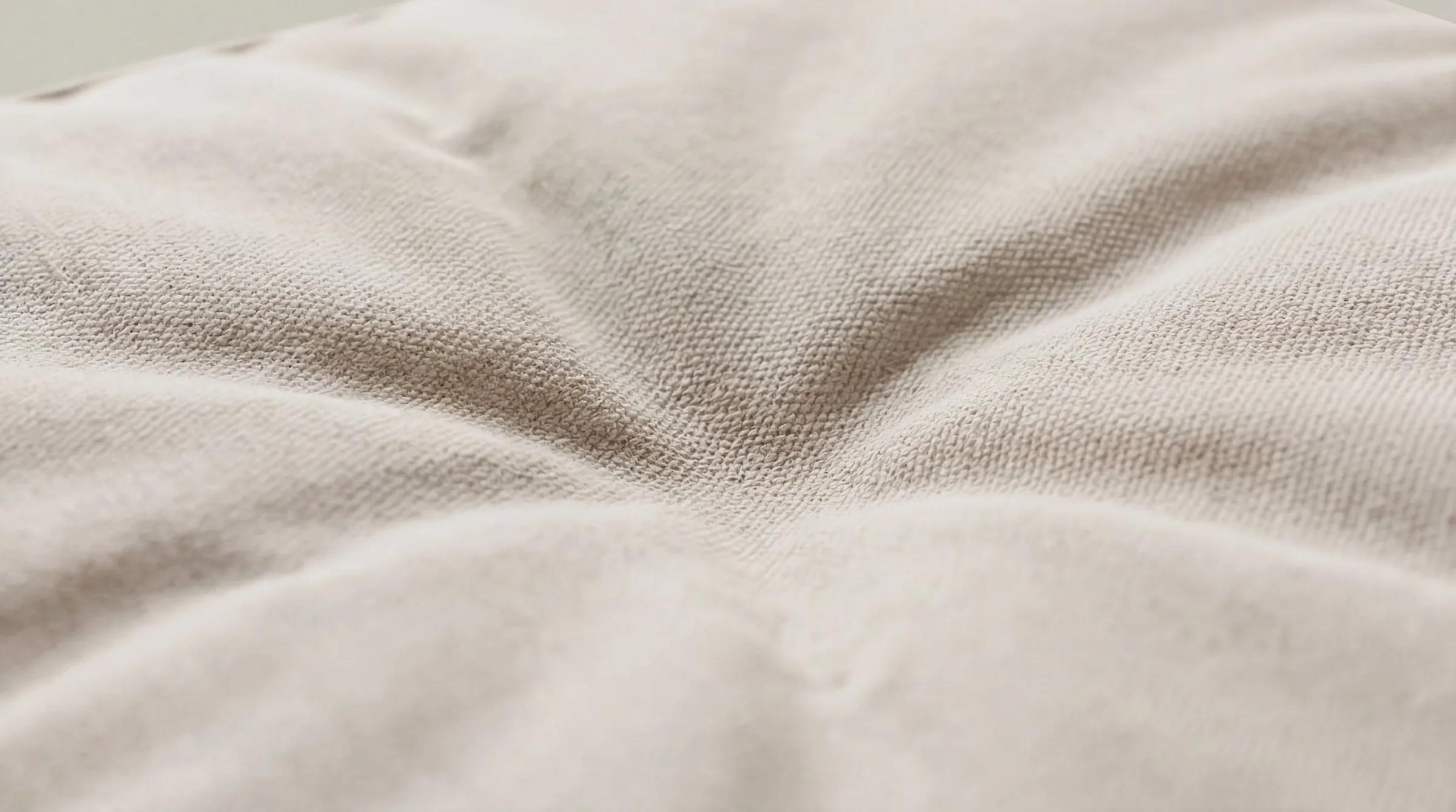 Tufted cushion surface in cream cotton